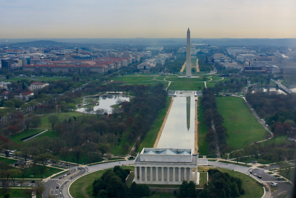 Institutionalism: The image is an aerial view of the Washington monument and the reflecting pond, showing the back of the Lincoln memorial in the foreground