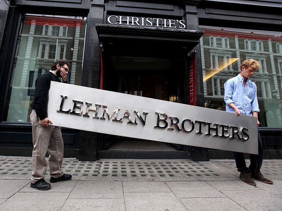 Angrynomics: Image of the Lehman Brothers sign being carried down the street