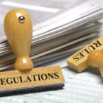 Image of papers with two stamps "bank regulations" and "rules"