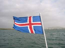 Political development: An image of a Iceland flag with the ocean behind it